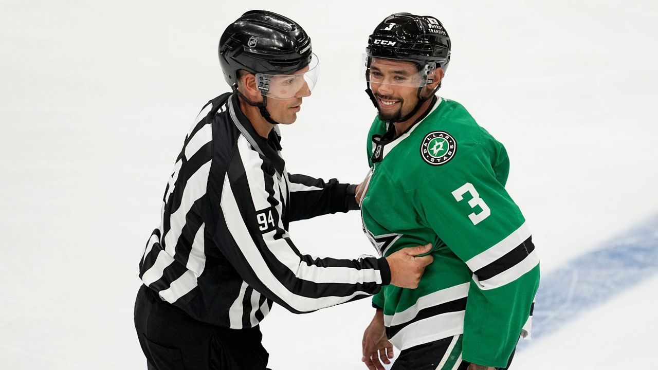 Linesman Bryan Pancich (94) holds Dallas Stars' Matt Dumba (3) back after a brief scuffle with Minnesota Wild players in the second period of a preseason NHL hockey game, Sept. 25, 2024, in Dallas. (AP Photo/Tony Gutierrez, File)