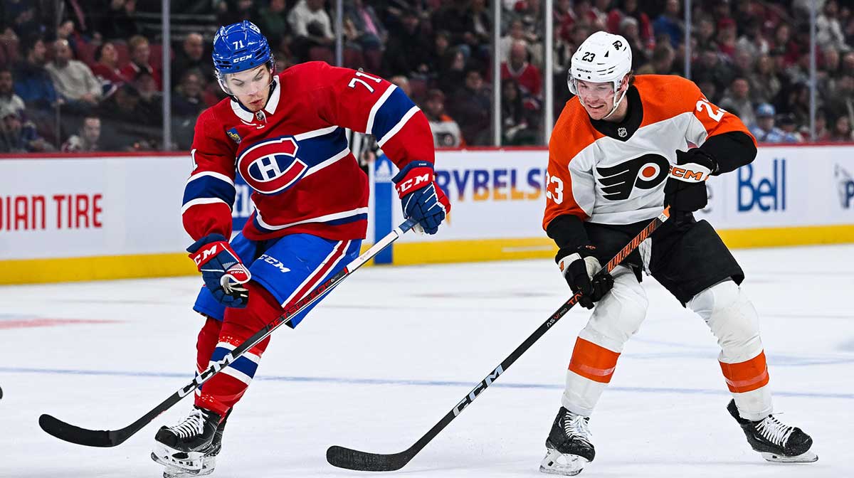 Philadelphia Flyers defenseman Ronnie Attard (23) plays the puck against Montreal Canadiens center Jake Evans (71) during the first period at Bell Centre. 