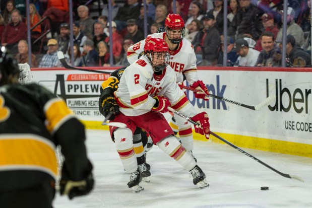 Defenseman Sean Behrens (2) of the Denver Pioneers moves the puck behind the net in the third period of the game against the Colorado College Tigers Friday, Nov. 3, 2023 at Magness Arena. (Photo by Daniel Brenner/Special to The Denver Post)