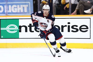 Columbus Blue Jackets forward Yegor Chinakhov skates with the puck during 2025 game.