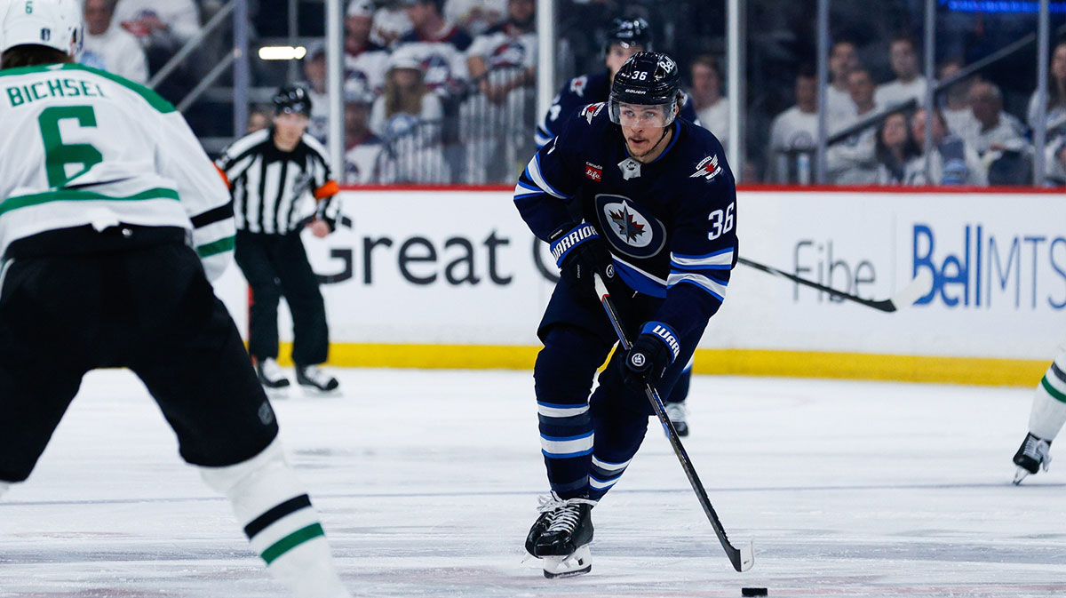 Winnipeg Jets forward Morgan Barron (36) controls the puck against Dallas Stars defenseman Liam Bichsel (6) during the second period in game five of the second round of the 2025 Stanley Cup Playoffs at Canada Life Centre. 