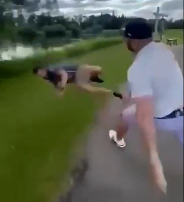 A fight breaking out on a golf course, one man being thrown into a pond.