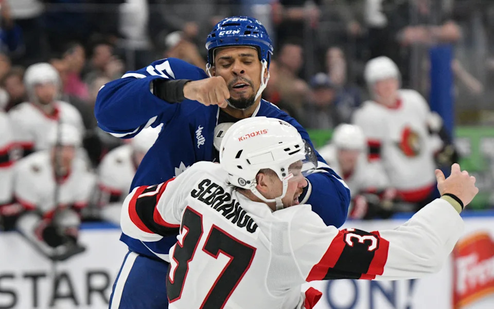Toronto Maple Leafs forward Ryan Reaves (75) fights with an Ottawa Senators player.Dan Hamilton-Imagn Images