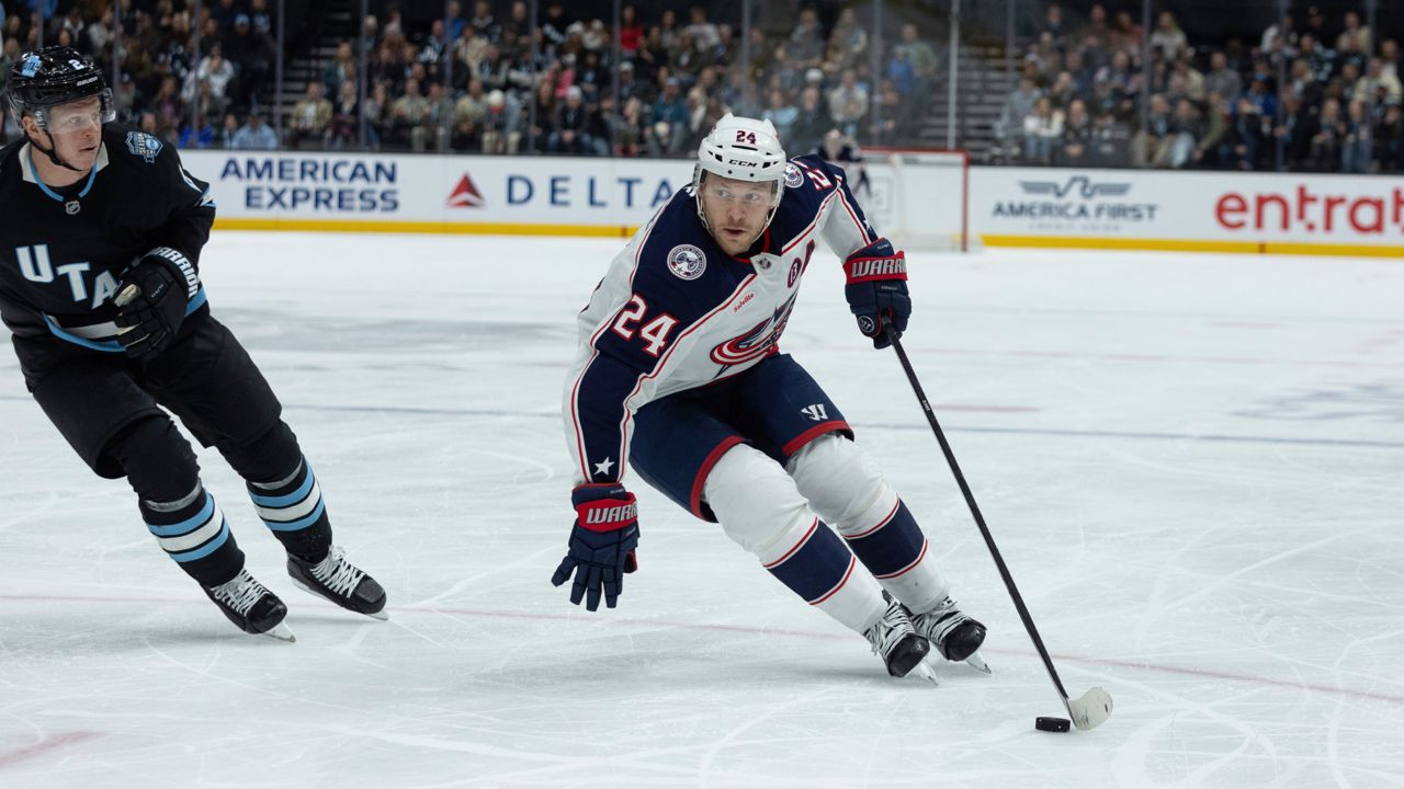 Columbus Blue Jackets right wing Mathieu Olivier (24) skates with the puck against Utah Hockey Club defenseman Olli Maatta (2) during the second period of an NHL hockey game Friday, Jan. 31, 2025, in Salt Lake City.
