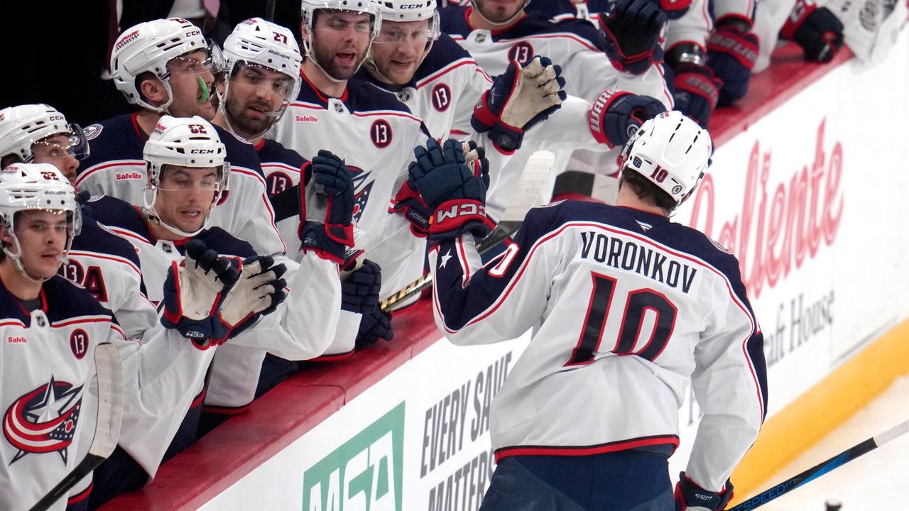 Columbus Blue Jackets' Dmitri Voronkov (10) returns to the bench after scoring during the first period of an NHL hockey game against the Pittsburgh Penguins in Pittsburgh, Tuesday, Jan. 7, 2025. (AP Photo/Gene J. Puskar)