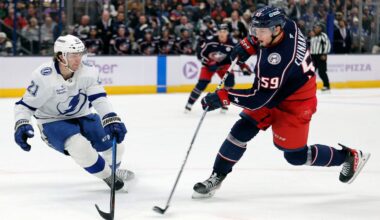 Tampa Bay Lightning forward Brayden Point, left, tries to block a shot by Columbus Blue Jackets forward Yegor Chinakhov, right, during the second period of an NHL hockey game in Columbus, Ohio, Thursday, Nov. 21, 2024.