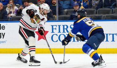 Chicago Blackhawks' Jason Dickinson (16) passes the puck while under pressure from St. Louis Blues' Matthew Kessel