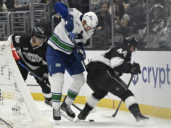 Dakota Joshua vies for the puck with Kings right wing Quinton Byfield (55) and defenceman Mikey Anderson (44) in Los Angeles in Feb.