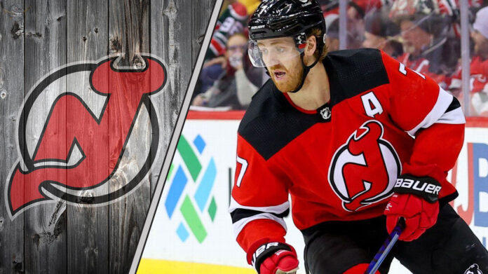 New Jersey Devils defenseman Dougie Hamilton looks on during an NHL game amid swirling NHL trade rumors.