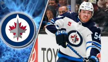 Winnipeg Jets defenseman Dylan Samberg skating during a game, highlighting the recent news of his contract arbitration filing.