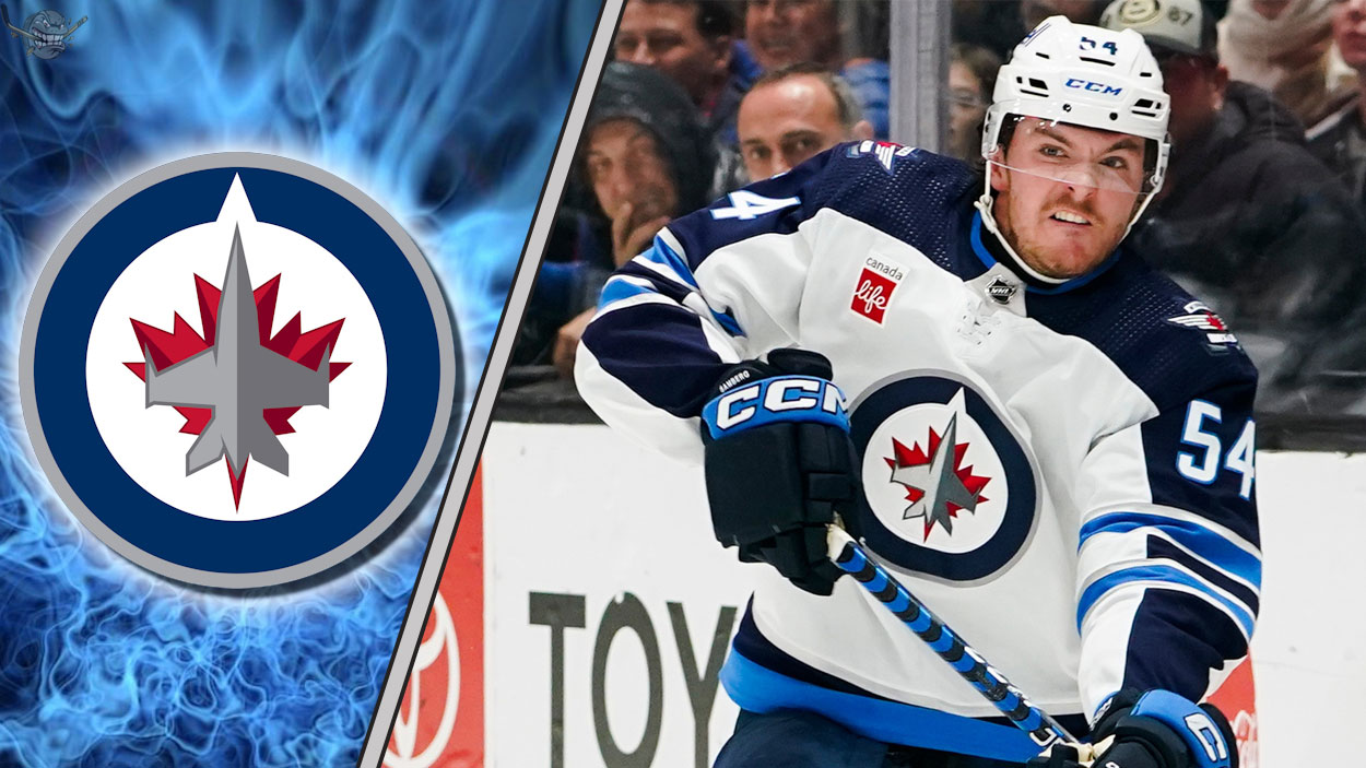 Winnipeg Jets defenseman Dylan Samberg skating during a game, highlighting the recent news of his contract arbitration filing.