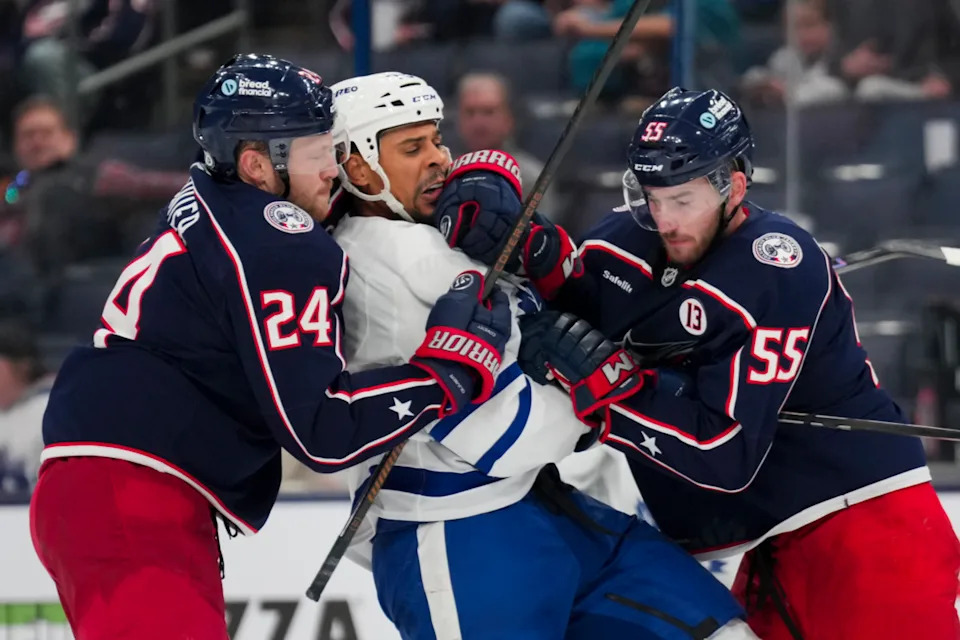 Former Toronto Maple Leafs right wing Ryan Reaves, middle, scrums with two opponents.Aaron Doster-Imagn Images