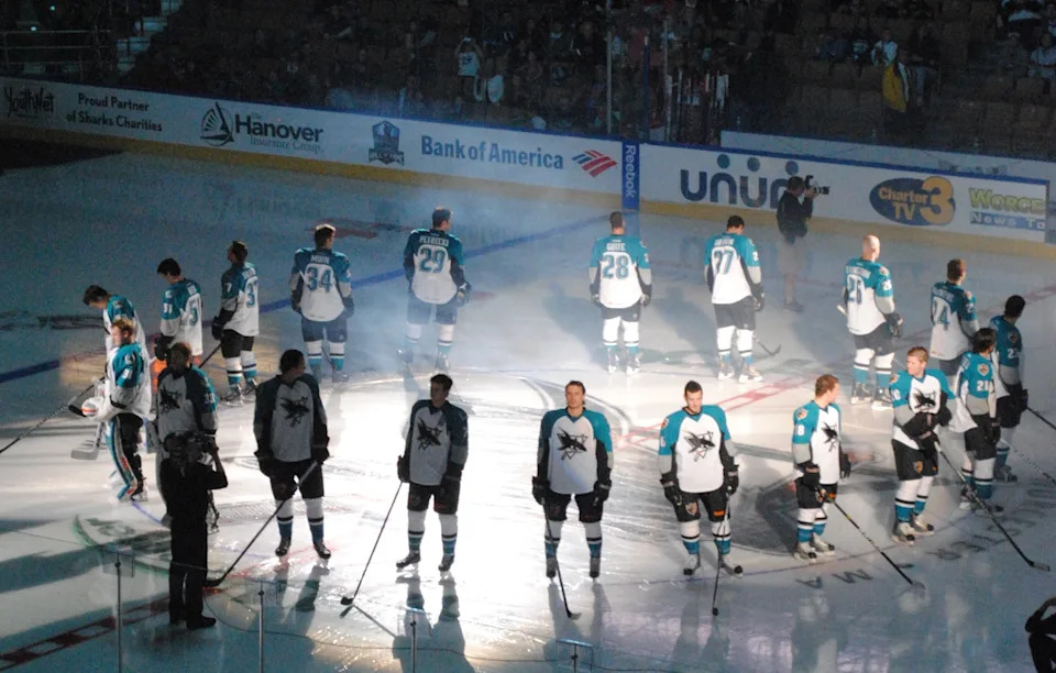 Worcester Sharks players line up around center ice at the DCU Center.