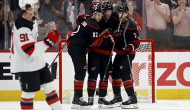 Carolina Hurricanes' Andrei Svechnikov, center, celebrates his goal with Jesperi Kotkaniemi (82) and Taylor Hall (71) during the third period of Game 1 of an NHL hockey Stanley Cup first-round playoff series against the New Jersey Devils in Raleigh, N.C., Sunday, April 20, 2025. (AP Photo/Karl DeBlaker)