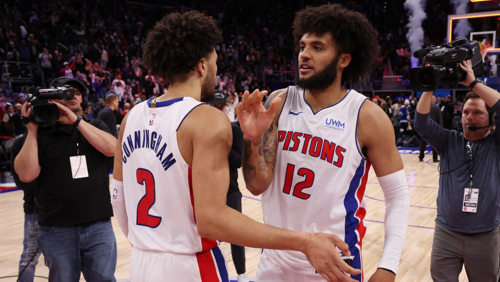 Isaiah Livers #12 and Cade Cunningham #2 of the Detroit Pistons react to a 129-127 win over the Tor...