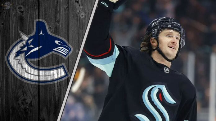 Jared McCann skates in his Seattle Kraken uniform, with the Vancouver Canucks logo faded into the background, illustrating recent NHL trade rumors.