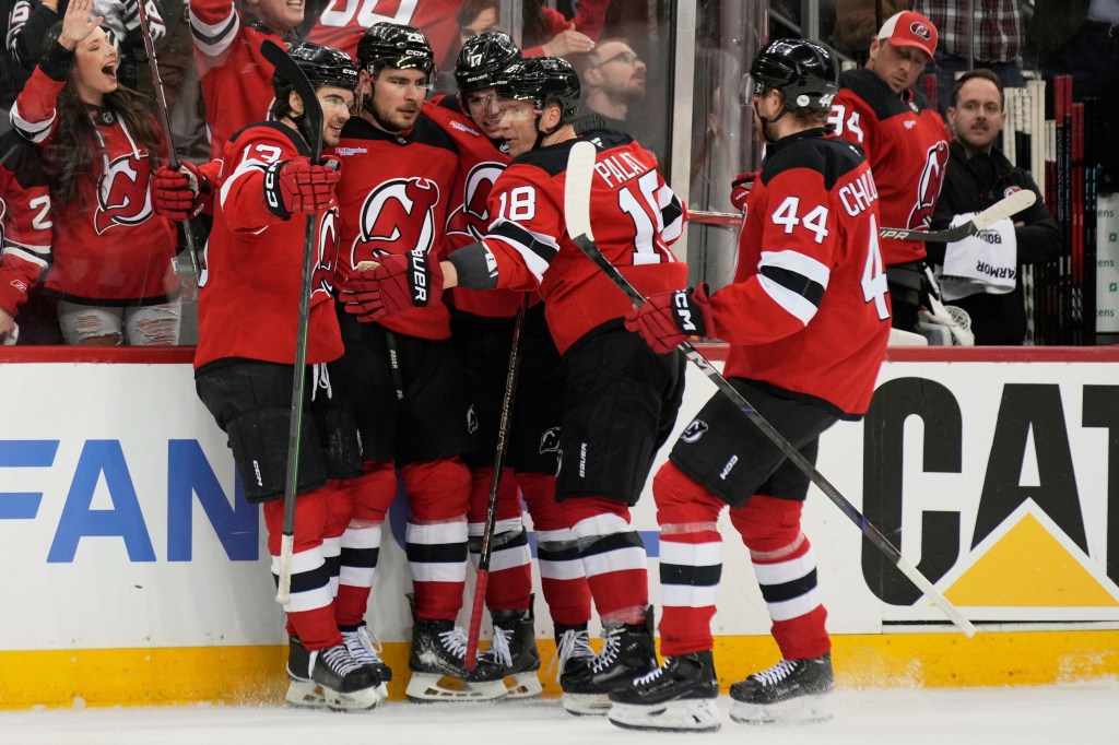 New Jersey Devils hockey players celebrating a goal.