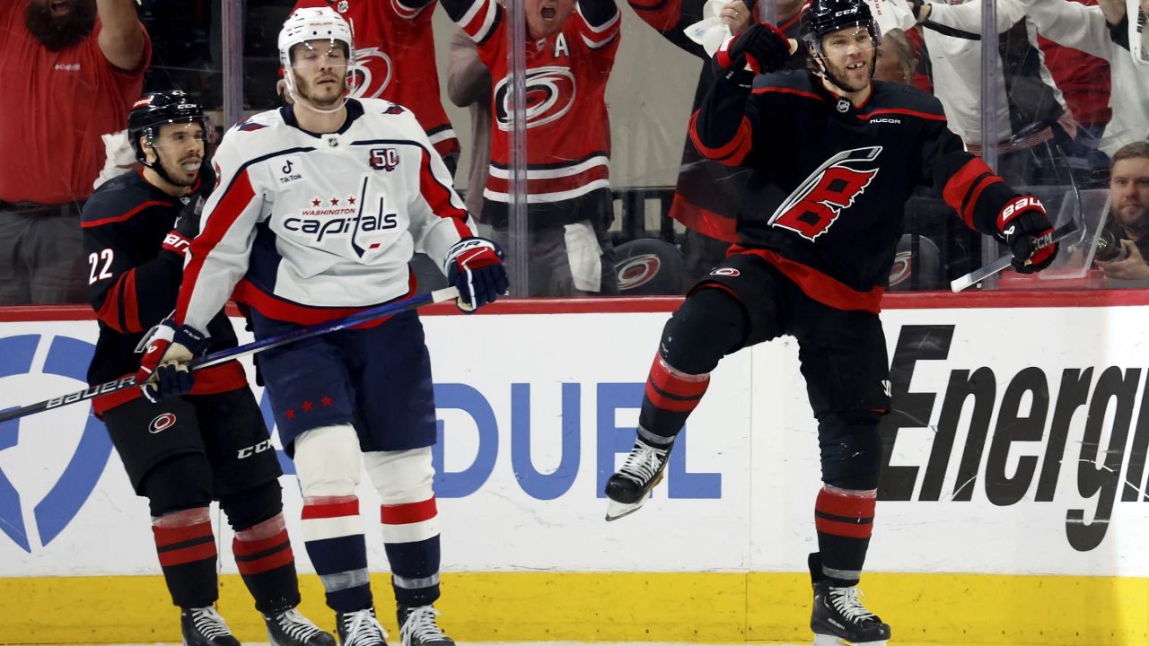 Carolina Hurricanes' Taylor Hall (71) celebrates after his goal with Washington Capitals' Matt Roy (3) nearby during the third period of Game 4 of second-round playoff series in Raleigh, N.C., Monday, May 12, 2025. (AP Photo/Karl DeBlaker)