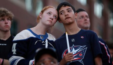 Blue Jackets fans Gianna,left, and Elijah Willis, have a moment of silence during the candlelight vigil to honor Columbus Blue Jackets hockey player Johnny Gaudreau, outside of Nationwide Arena in Columbus, Ohio, Thursday, Sept. 4, 2024.