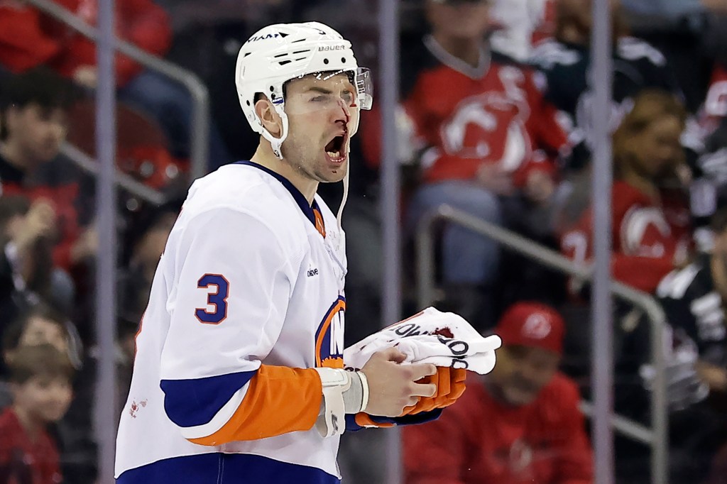 Islanders defenseman Adam Pelech (3) yells after being hit by New Jersey Devils center Paul Cotter in the second period of an NHL hockey game Sunday, April 13, 2025, in Newark, N.J. 