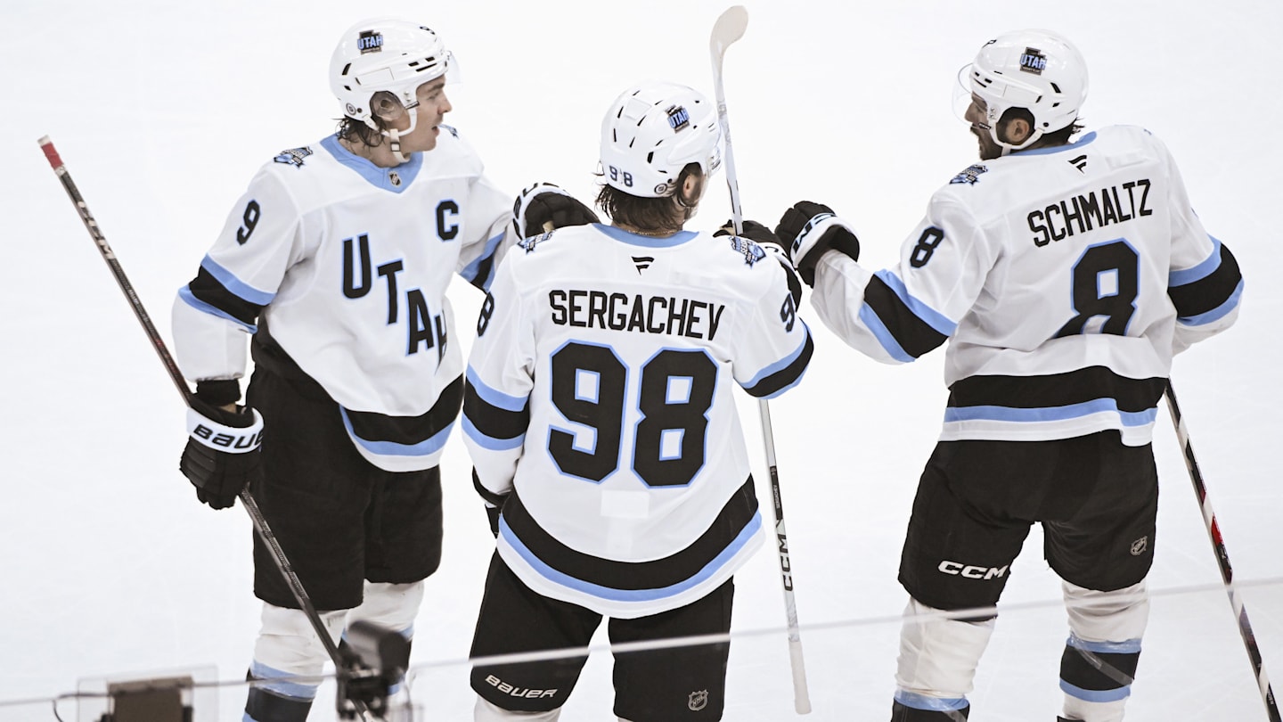 Mar 7, 2025; Chicago, Illinois, USA;   Utah Hockey Club center Clayton Keller (9) celebrates with defenseman Mikhail Sergachev (98) and Utah Hockey Club center Nick Schmaltz (8) after he scored a goal against the Chicago Blackhawks during the third period  at the United Center. Mandatory Credit: Matt Marton-Imagn Images