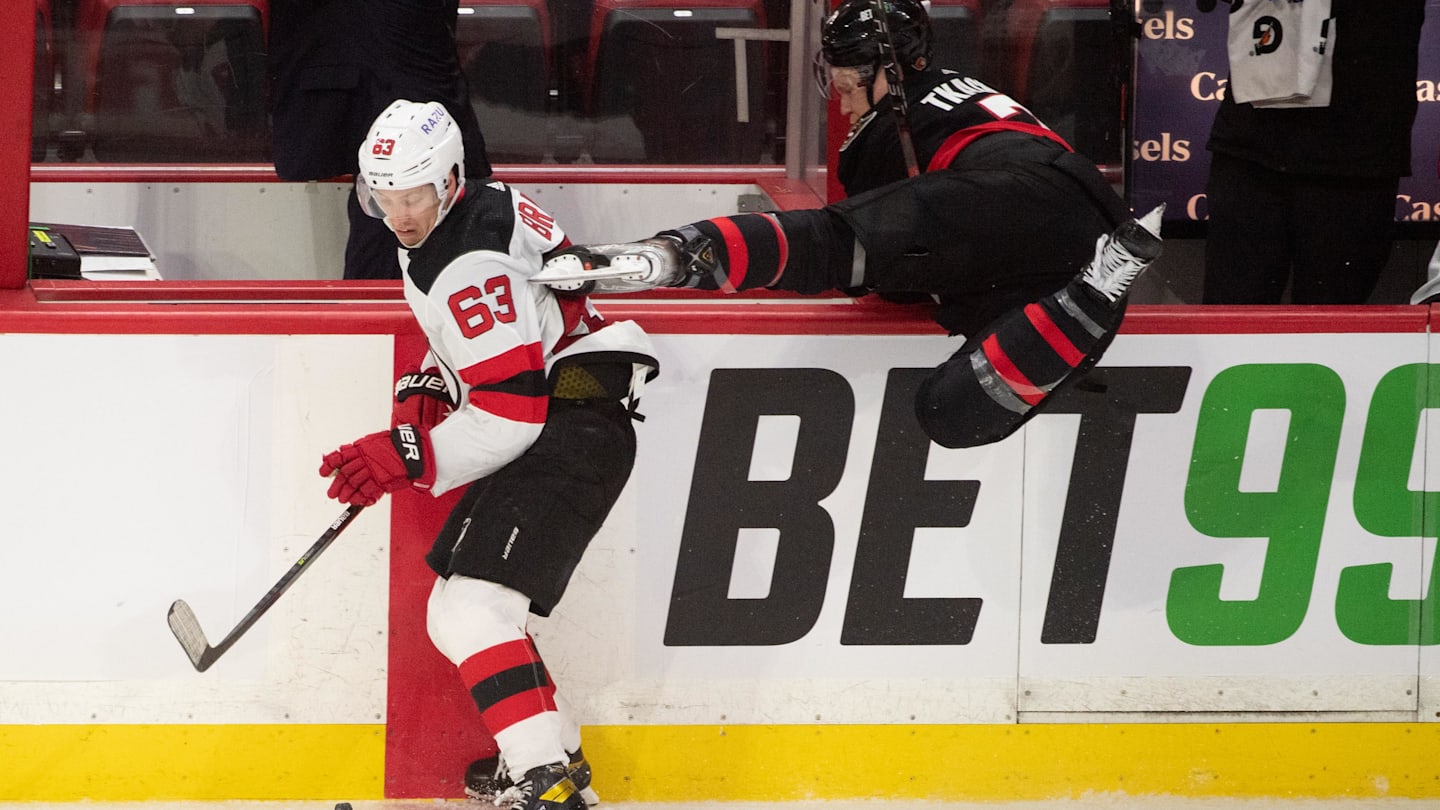 New Jersey Devils left wing Jesper Bratt (63) evades a check from Ottawa Senators left wing Brady Tkachuk (7). Mandatory Credit: Marc DesRosiers-Imagn Images