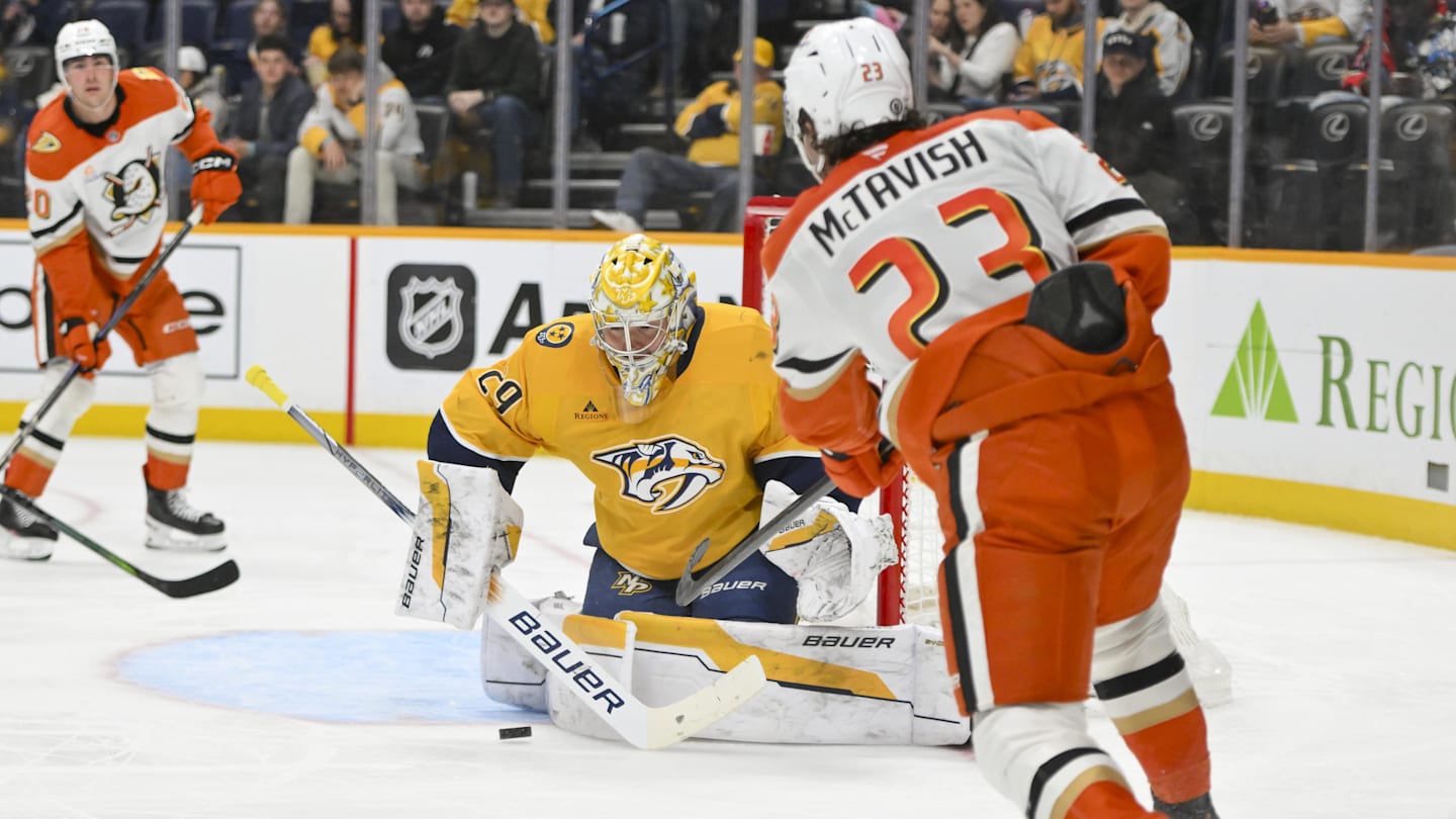 Mar 20, 2025; Nashville, Tennessee, USA;  Nashville Predators goaltender Justus Annunen (29) blocks the shot of Anaheim Ducks center Mason McTavish (23) during the second period at Bridgestone Arena. Mandatory Credit: Steve Roberts-Imagn Images