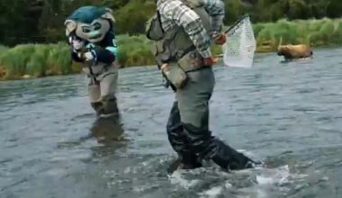 Kraken mascot, Buoy, is seen retreating from a charging brown bear in the Alaska wilderness
