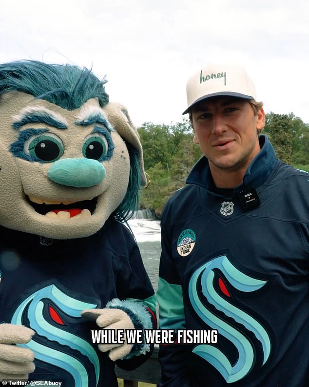Seattle's John Hayden with Kraken mascot, Buoy, which isn't a seam monster, but a troll