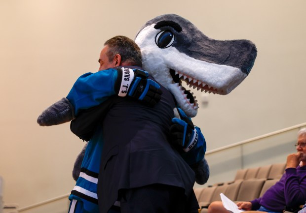 San Jose Sharks President Jonathan Becher gets a hug from...