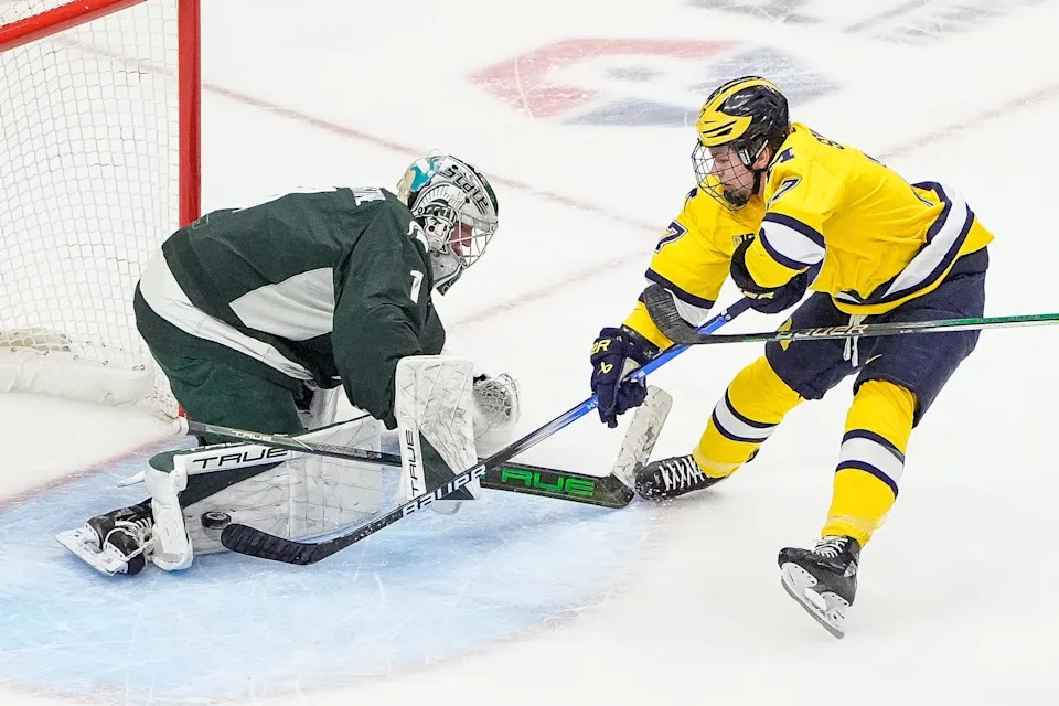 Michigan State goaltender Trey Augustine (1) makes a save against against Michigan forward Garrett Schifsky (17) during the first period of Duel in the D at Little Caesars Arena in Detroit on Saturday, Feb. 8, 2025.