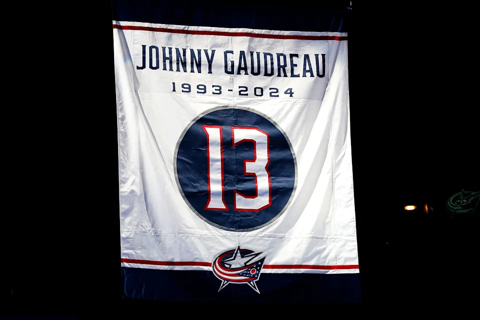 A banner is raised in remembrance of Johnny Gaudreau before the Columbus Blue Jackets' home opener.
