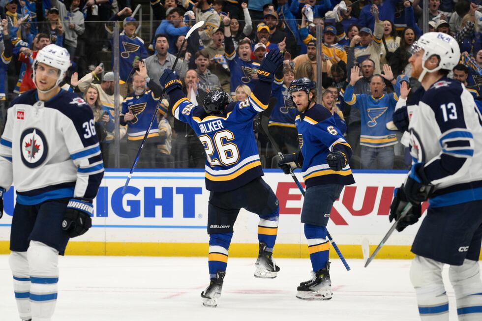 St. Louis Blues left wing Nathan Walker (26) reacts with defenseman Philip Broberg (6) after...