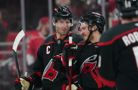 Jan 9, 2025; Raleigh, North Carolina, Carolina Hurricanes center Jordan Staal (11) and center Jack Roslovic (96) celebrate after their victory against the Toronto Maple Leafs at Lenovo Center. Mandatory Credit: James Guillory-Imagn Images