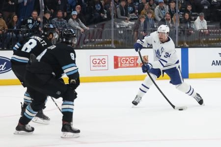 Mar 10, 2025; Salt Lake City, Utah, USA; Toronto Maple Leafs center Auston Matthews (34) takes a shot as Utah Hockey Club center Nick Schmaltz (8) and center Clayton Keller (9) defend during overtime at Delta Center. Mandatory Credit: Rob Gray-Imagn Images Mar 10, 2025; Salt Lake City, Utah, USA; Toronto Maple Leafs center Auston Matthews (34) takes a shot as Utah Hockey Club center Nick Schmaltz (8) and center Clayton Keller (9) defend during overtime at Delta Center. Mandatory Credit: Rob Gray-Imagn Images