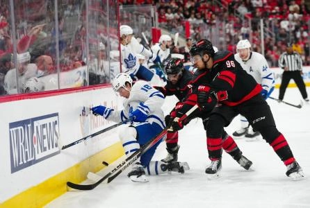 Carolina Hurricanes forward Jack Roslovic fighting for a loose puck along the boards against Toronto Maple Leafs winger Mitch Marner. Carolina Hurricanes forward Jack Roslovic fighting for a loose puck along the boards against Toronto Maple Leafs winger Mitch Marner.