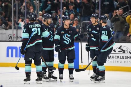 Seattle Kraken players together on the ice Seattle Kraken players together on the ice