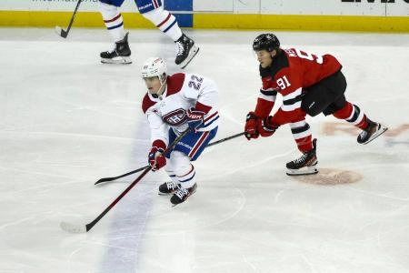 Feb 24, 2024; Newark, New Jersey, USA; Montreal Canadiens right wing Cole Caufield (22) skates with the puck while being defended by New Jersey Devils center Dawson Mercer (91) during the third period at Prudential Center. Mandatory Credit: John Jones-Imagn Images