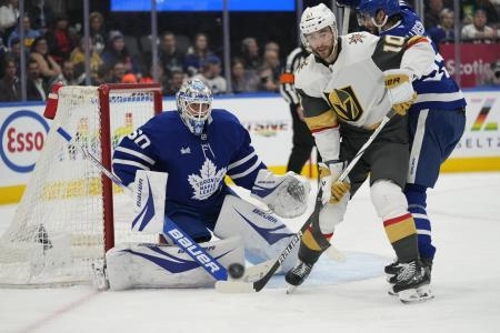 Nov 20, 2024; Toronto, Ontario, CAN; Vegas Golden Knights forward Nicolas Roy (10) tries to deflect a puck at Toronto Maple Leafs goaltender Joseph Woll (60) during the second period at Scotiabank Arena