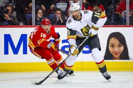 Vegas Golden Knights forward Nic Roy battling against Calgary Flames forward Morgan Frost. Vegas Golden Knights forward Nic Roy battling against Calgary Flames forward Morgan Frost.