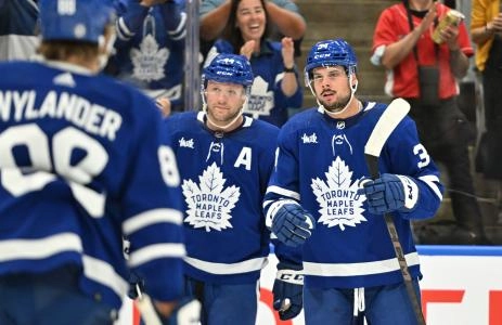 Oct 5, 2023; Toronto, Ontario, CAN; Toronto Maple Leafs forward Auston Matthews (34) celebrates with defenseman Morgan Rielly (44) and forward William Nylander (88) after scoring a goal against the Detroit Red Wings in the first period at Scotiabank Arena