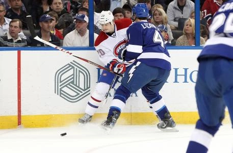 March 9, 2013; Tampa FL, USA; Montreal Canadiens right wing Colby Armstrong (20) passes the puck past Tampa Bay Lightning center Vincent Lecavalier (4) during the first period at Tampa Times Forum. Mandatory Credit: Kim Klement-Imagn Images March 9, 2013; Tampa FL, USA; Montreal Canadiens right wing Colby Armstrong (20) passes the puck past Tampa Bay Lightning center Vincent Lecavalier (4) during the first period at Tampa Times Forum. Mandatory Credit: Kim Klement-Imagn Images