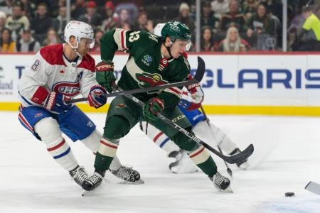 Dec 21, 2023; Saint Paul, Minnesota, USA; Minnesota Wild center Marco Rossi (23) shoots Montreal Canadiens defenseman Mike Matheson (8) on defense in the first period at Xcel Energy Center. Mandatory Credit: Matt Blewett-Imagn Images