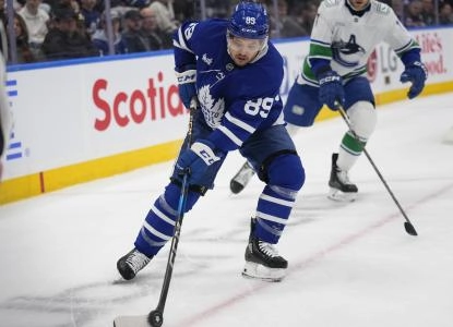 Toronto Maple Leafs forward Nicholas Robertson carrying the puck against the Vancouver Canucks. Toronto Maple Leafs forward Nicholas Robertson carrying the puck against the Vancouver Canucks.