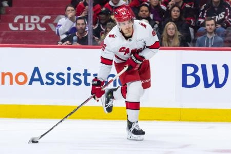 Apr 17, 2025; Ottawa, Ontario, CAN; Carolina Hurricanes center Jack Roslovic (96) shoots the puck in the second period against the Ottawa Senators at the Canadian Tire Centre. Mandatory Credit: Marc DesRosiers-Imagn Images