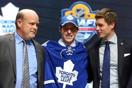 Mitch Marner stands proudly between Mark Hunter and Kyle Dubas at the 2015 NHL Draft, moments after being selected 4th overall by the Toronto Maple Leafs.