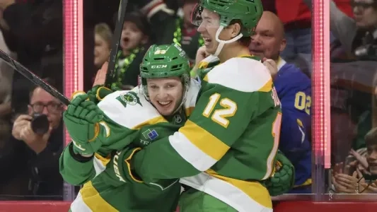 Minnesota Wild's Marco Rossi hugs his teammate to celebrate
