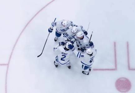 Apr 13, 2025; Raleigh, North Carolina, USA; Toronto Maple Leafs right wing William Nylander (88) is congratulated after his goal by defenseman Chris Tanev (8), defenseman Simon Benoit (2), center John Tavares (91) and center Max Domi (11) against the Carolina Hurricanes during the third periodat Lenovo Center. Mandatory Credit: James Guillory-Imagn Images