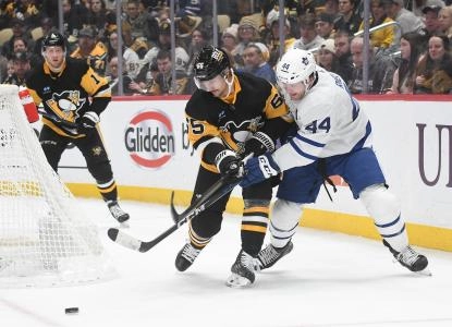 Toronto Maple Leafs defenseman Morgan Rielly in battle with Pittsburgh Penguins defenseman Erik Karlsson.