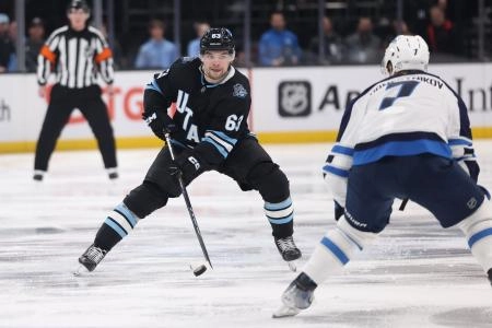 Jan 20, 2025; Salt Lake City, Utah, USA; Utah Hockey Club left wing Matias Maccelli (63) skates against Winnipeg Jets center Vladislav Namestnikov (7) during the second period at Delta Center. Mandatory Credit: Rob Gray-Imagn Images